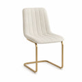Silla de tela beige con estructura de acero dorado