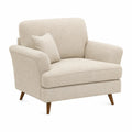 Sofá individual de tela bouclé beige con cojín y patas de madera